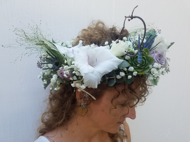 Holly wearing a white and purple floral crown created by District 2 Floral Studio.
