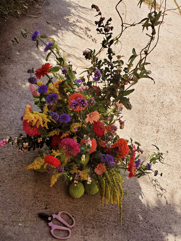 Large, bright flower arrangement by District 2 Floral Studio created with locally grown flowers.