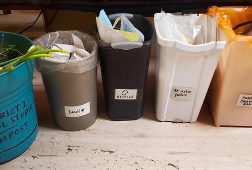 Landfill diversion practices at District 2 Floral Studio showing the following bins: compost, landfill, recycling, reusable plastic, and Hefty Renew Orange bags.