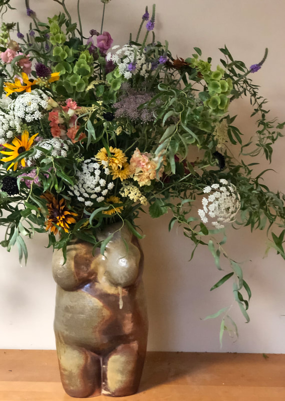 Flower arrangement by District 2 Floral Studio created with locally grown flowers in a ceramic vase by Anna Stoysich.