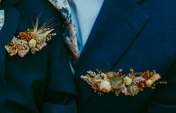 Navy wedding suit jacket with a pocket boutonniere created with locally grown flowers created by District 2 Floral Studio.