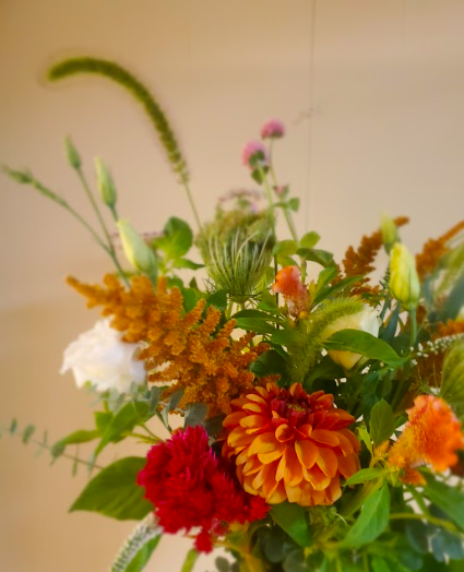 Red and orange flower arrangement by District 2 Floral Studio created with locally grown flowers.