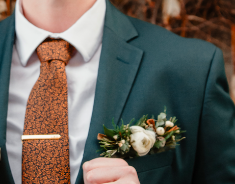 Deep green wedding suit jacket with a pocket boutonniere created with locally grown flowers created by District 2 Floral Studio.
