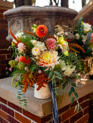Rust orange and soft pink summer August wedding bridal bouquet in a custom ceramic vase by District 2 Floral Studio using locally-grown flowers.