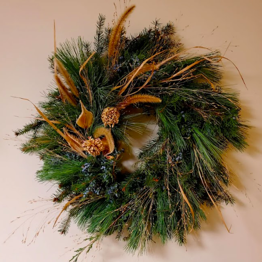 Seasonal winter wreath created by District 2 Floral Studio with locally grown Nebraska evergreens and dried grasses.