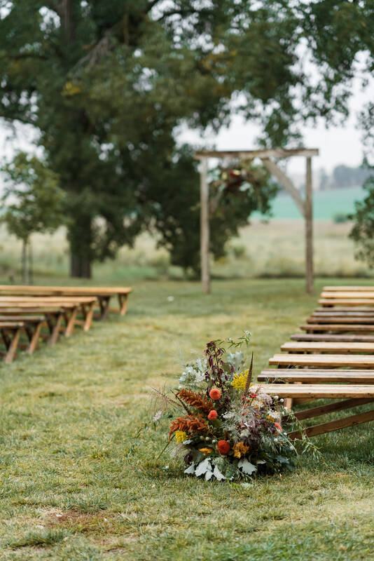 Outdoor wedding ceremony grounded meadow created by District 2 Floral Studio with locally grown Nebraska flowers.